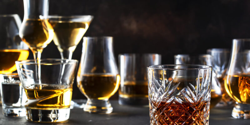 strong alcoholic drinks, spirits and distillates in glasses in assortment: vodka, cognac, scotch